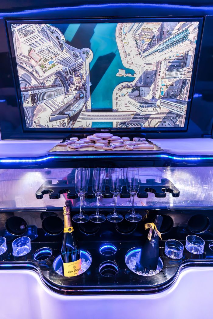 The Sprinter's bar set with champagne on ice, four flutes, and iced cookies on a gold tray.